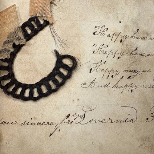 lock of braided hair taped into a book, courtesy of University Archives